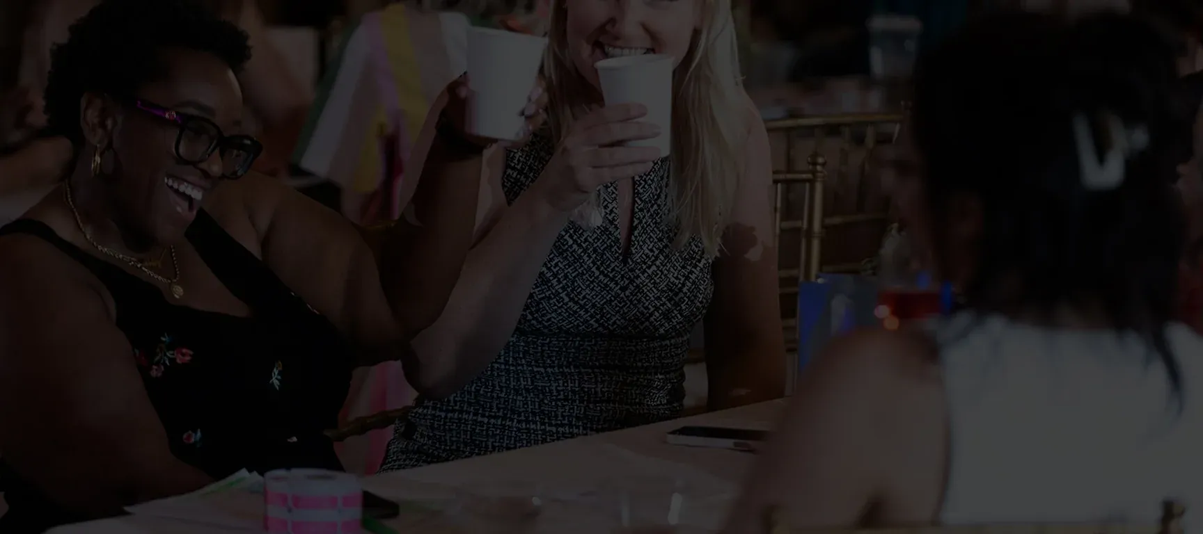 Women laughing and connecting at a Powered by Women event