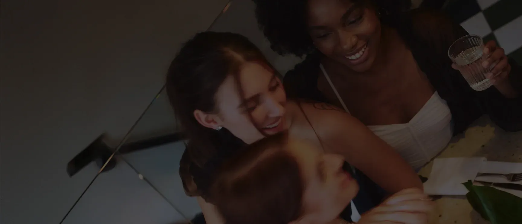 Friends sharing a joyful moment around a table
