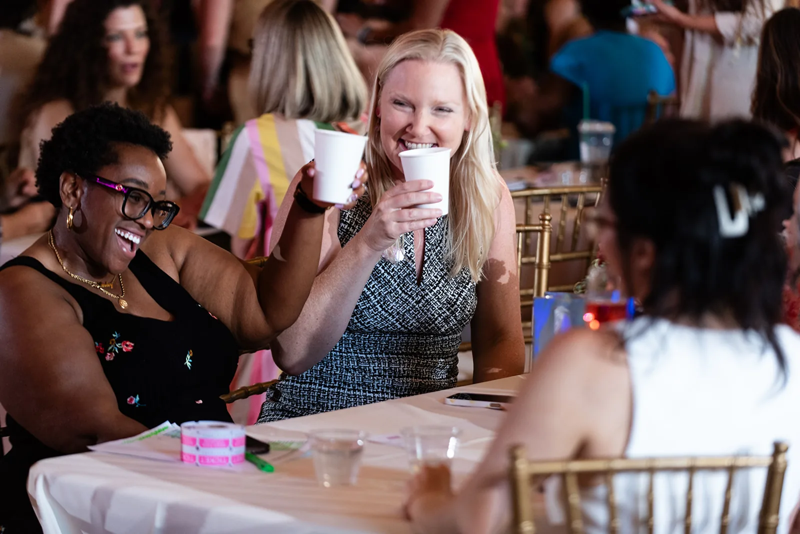 Women laughing and connecting at a Powered by Women event